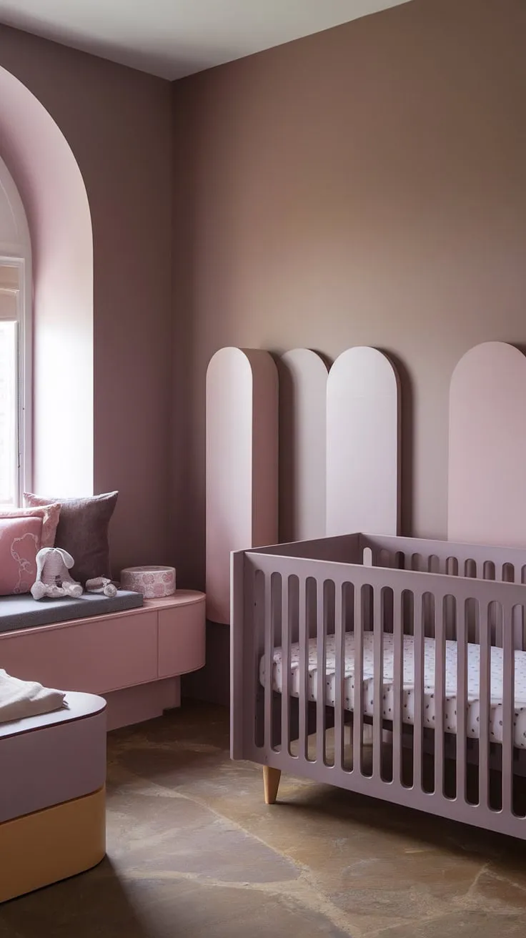 A light brown accent wall nursery creates a stunning focal point in this serene neutral purple nursery.  The taupe and pink colour scheme is beautifully balanced, with a crib on the window wall bathed in natural light.  The grey and mauve nursery furniture set adds a touch of elegance against the Sashay Sand Sherwin Williams walls, all grounded by the warm cinnamon slate nursery floor.  A truly captivating girl nursery room wall design.