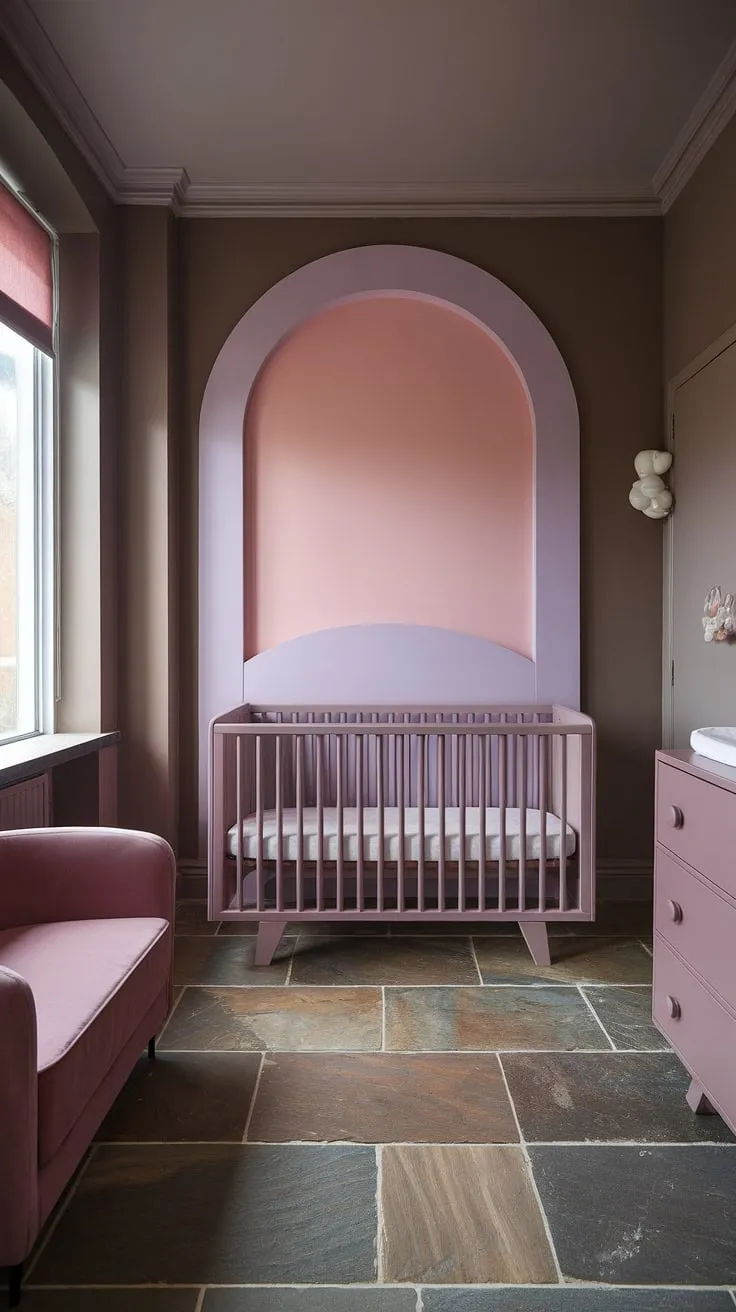 A gentle Sashay Sand Sherwin Williams palette sets the tone in this light brown accent wall nursery, creating a haven of calm for your little one. The taupe and pink nursery features a captivating accent girl nursery room wall in shades of purple and pink, perfectly complementing the mauve furniture and cinnamon slate nursery floor.  The crib, nestled by the window, overlooks a world of dreams in this neutral purple nursery, a beautiful example of grey and mauve nursery design.