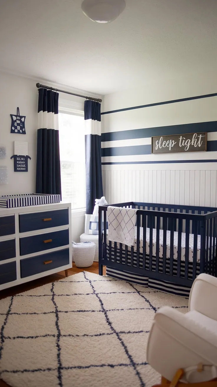 This nautical-themed baby boy nursery is pure baby room inspiration. The striped accent nursery wall sets a calming tone, complemented by the navy crib and white dresser.  A perfect blend of baby room themes and nursery room design, offering plenty of nursery inspo for parents-to-be.  This baby boy room is a dream come true, showcasing the best in baby nursery inspiration and baby room design.