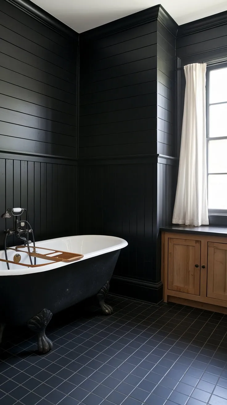 All black bathroom goals achieved. This minimalist space, featuring black bathroom wainscoting and black bathroom decor ideas, proves that a monochrome palette can be incredibly luxurious. Explore black wainscoting and clawfoot tub ideas for your own dramatic bathroom transformation.