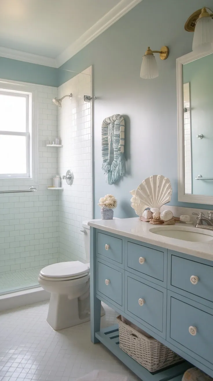 White tile floors and soft blue walls complete this charming farmhouse-style coastal bathroom.