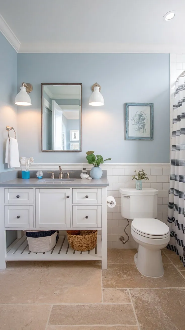 A modern beach-themed bathroom renovation features a calming palette of blues, whites, and beige, creating a tranquil coastal escape.