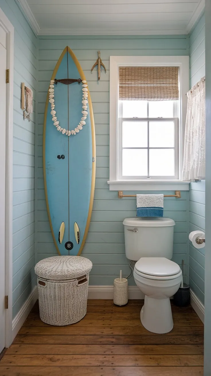 Escape to this serene coastal small bathroom, where blue beach bathroom ideas meet white coastal bathroom ideas for the ultimate coastal aesthetic bathroom.  The surf theme, complete with a surfboard and puka shell necklace, perfectly captures a beach house bathroom aesthetic, offering a tranquil beach aesthetic bathroom ideas retreat.  This beach cottage style bathroom is small but perfectly formed.