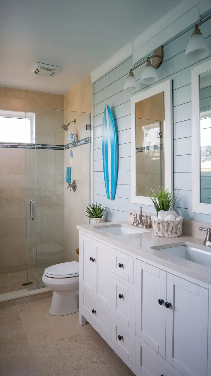 Escape to the coast every morning in this serene coastal small bathroom.  The perfect blend of blue beach bathroom ideas and white coastal bathroom ideas creates a calming coastal aesthetic bathroom, embodying the relaxed beach house bathroom aesthetic.  This beach aesthetic bathroom design, with its subtle surf theme bathroom accents, offers a taste of beach cottage style bathroom charm without sacrificing space.