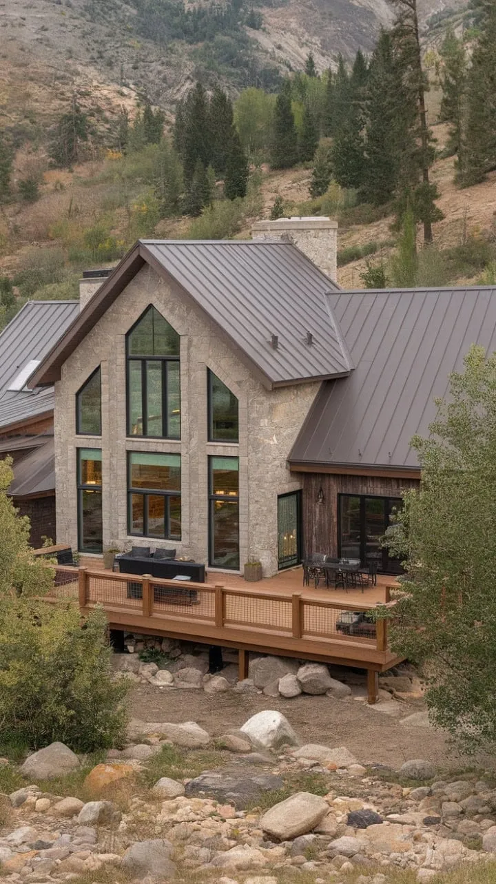 This mountain home masterfully combines natural stone, sleek metal, and warm wood, creating a unique sanctuary that seamlessly merges comfort with breathtaking views of nature.