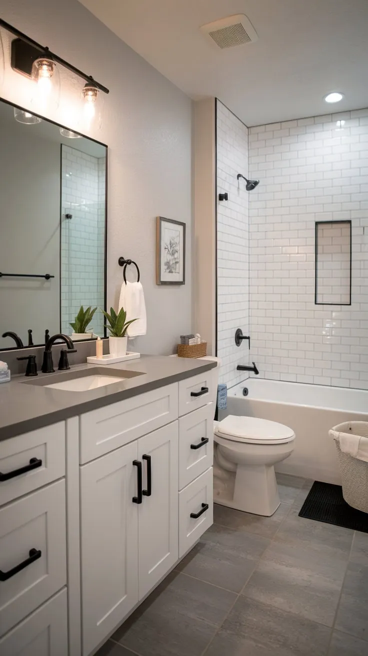 Gray tones and black accents define this stylish modern farmhouse bathroom, creating a tranquil retreat.