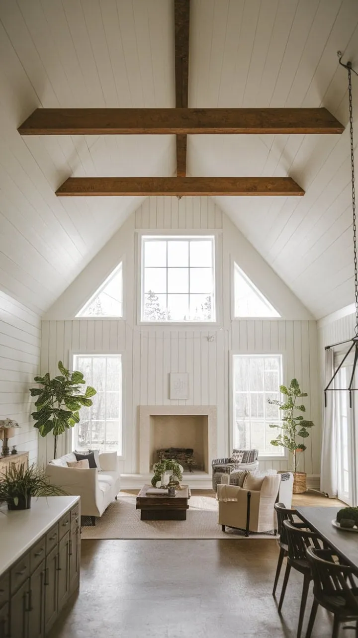 Bathed in sunlight, this minimalist farmhouse harmoniously fuses rustic charm with modern simplicity, featuring an airy open layout that highlights a vaulted ceiling and a cozy stone fireplace.