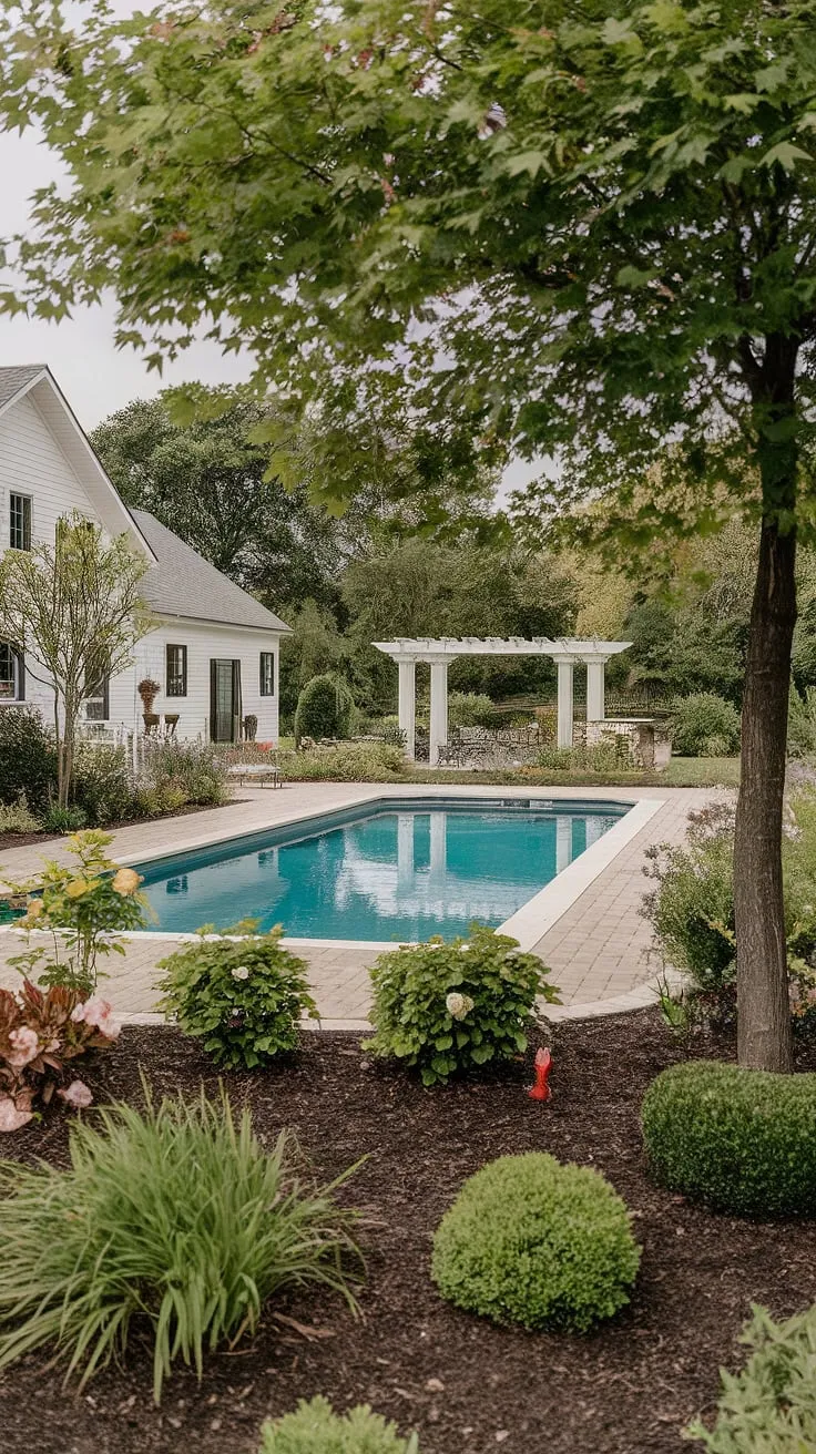 This farmhouse embodies the perfect blend of rustic charm and modern luxury. A sparkling pool, surrounded by lush greenery and thoughtfully designed landscaping, creates an oasis of calm. The inviting pergola and meticulously placed pavers complete this idyllic escape. A dream come true.