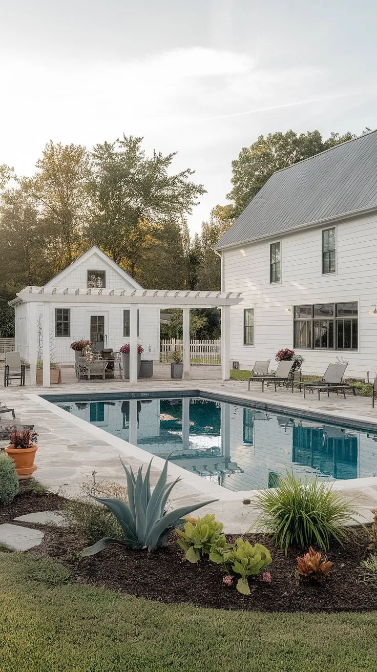 This stunning farmhouse boasts a picturesque backyard oasis. A sparkling pool, complete with a delightful pool house and pergola, invites you to unwind and soak up the sun. The meticulously landscaped grounds and charming stone patio offer a perfect blend of rustic charm and modern comfort. A dream come true.