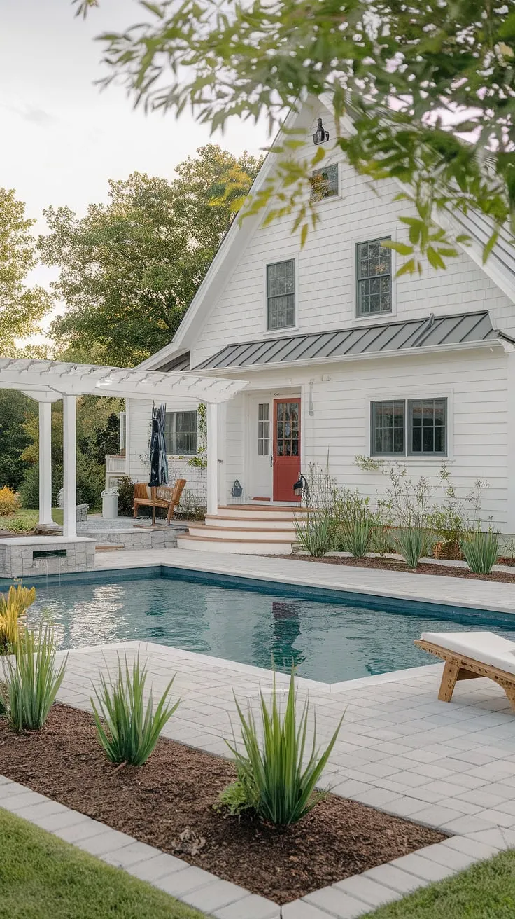 Country living at its finest. This farmhouse, with its charming red door and inviting pool area, offers the perfect blend of rustic charm and modern comfort. The meticulously landscaped patio, complete with a pergola and comfortable seating, provides an idyllic setting for relaxation and entertainment. A true escape.