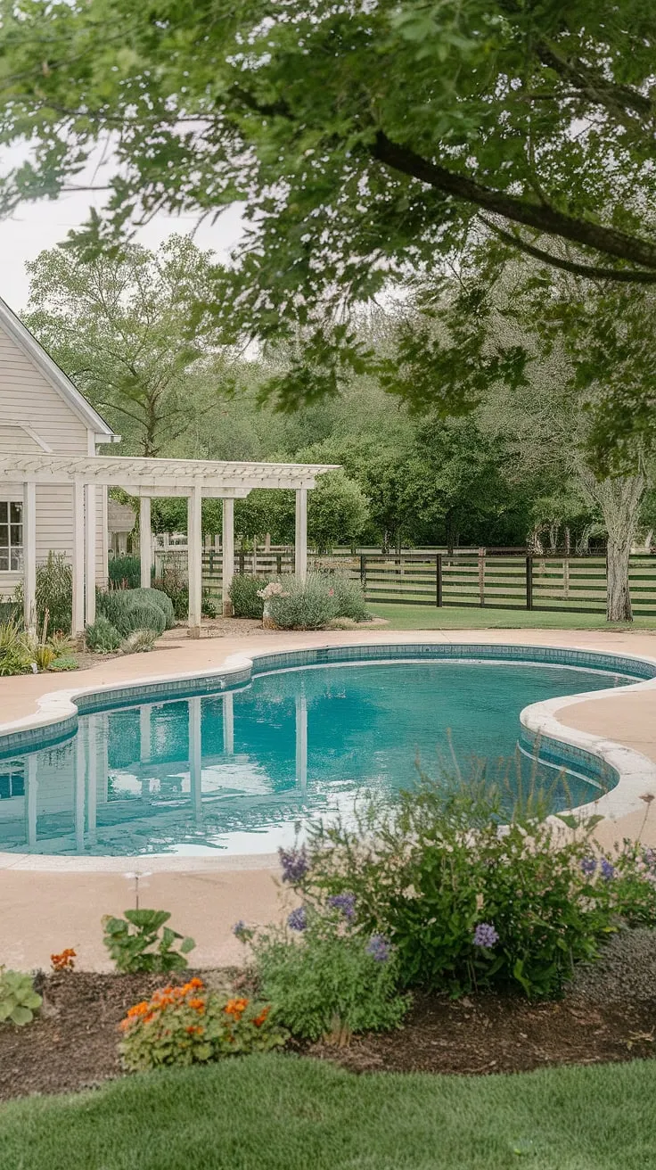Summer days spent lounging by the pool under the shade of the pergola, a true escape at this idyllic farmhouse. The classic pool design and lush landscaping create a tranquil oasis, a perfect blend of rustic charm and modern comfort. A peaceful retreat awaits.