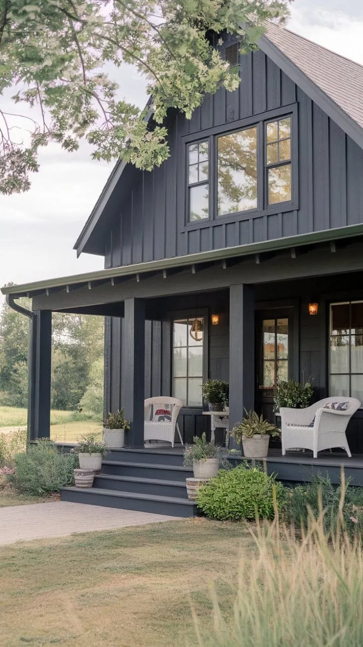 This gray farmhouse harmoniously fuses craftsman details with modern charm, offering a serene retreat enhanced by a welcoming porch and lush greenery.
