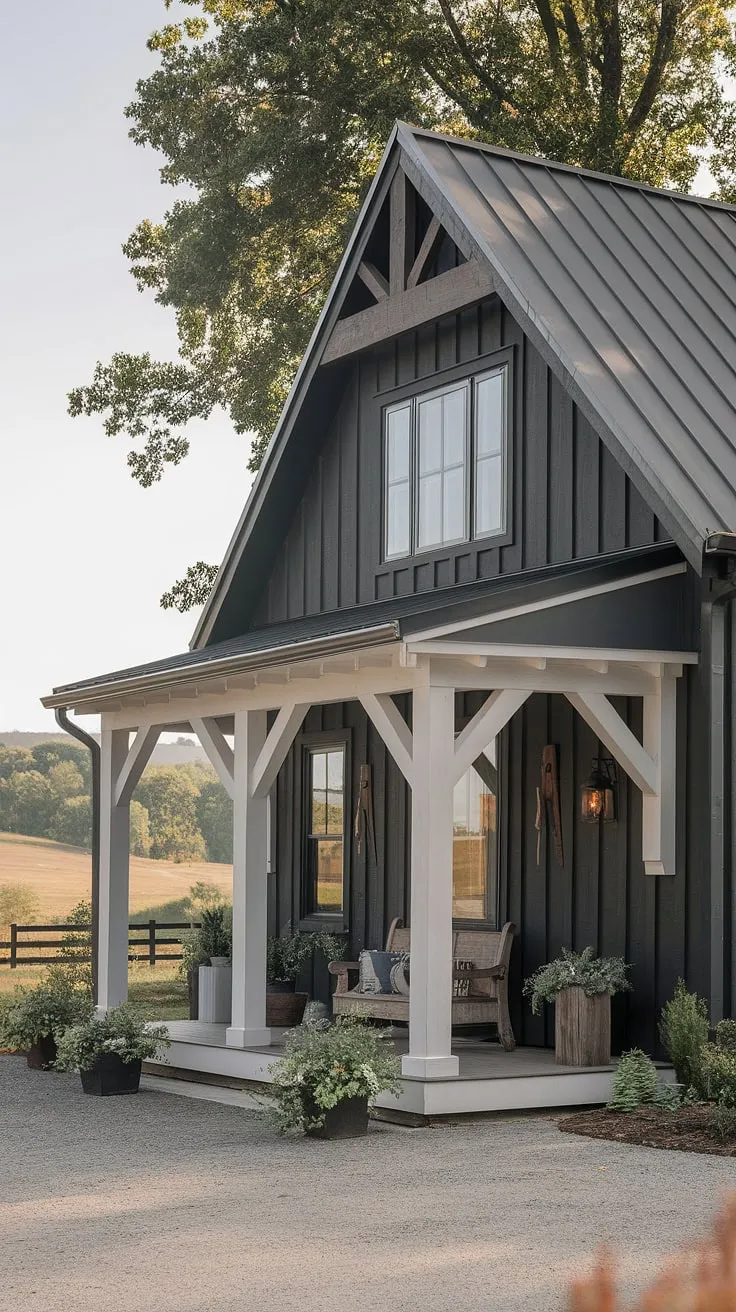 A stunning blend of modern and craftsman styles, this dark gray farmhouse stands proudly amidst rolling hills. The added porch, complete with white columns and rustic decor, creates a warm and inviting atmosphere. A perfect example of how architectural details and thoughtful landscaping can transform a house into a home.