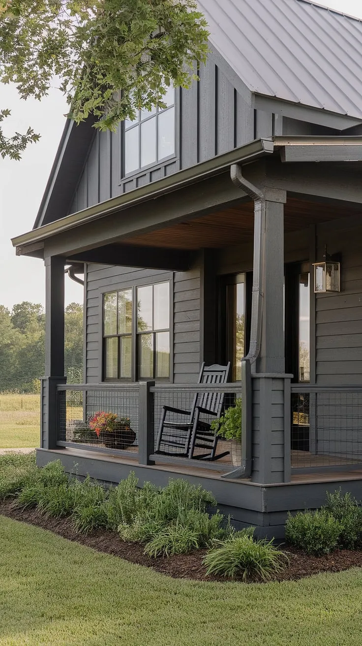 This craftsman-style home, nestled on a sprawling rural property, exudes quiet elegance. The dark gray siding and dark wood details create a striking aesthetic, while the inviting porch, complete with a rocking chair and potted plant, promises peaceful evenings.