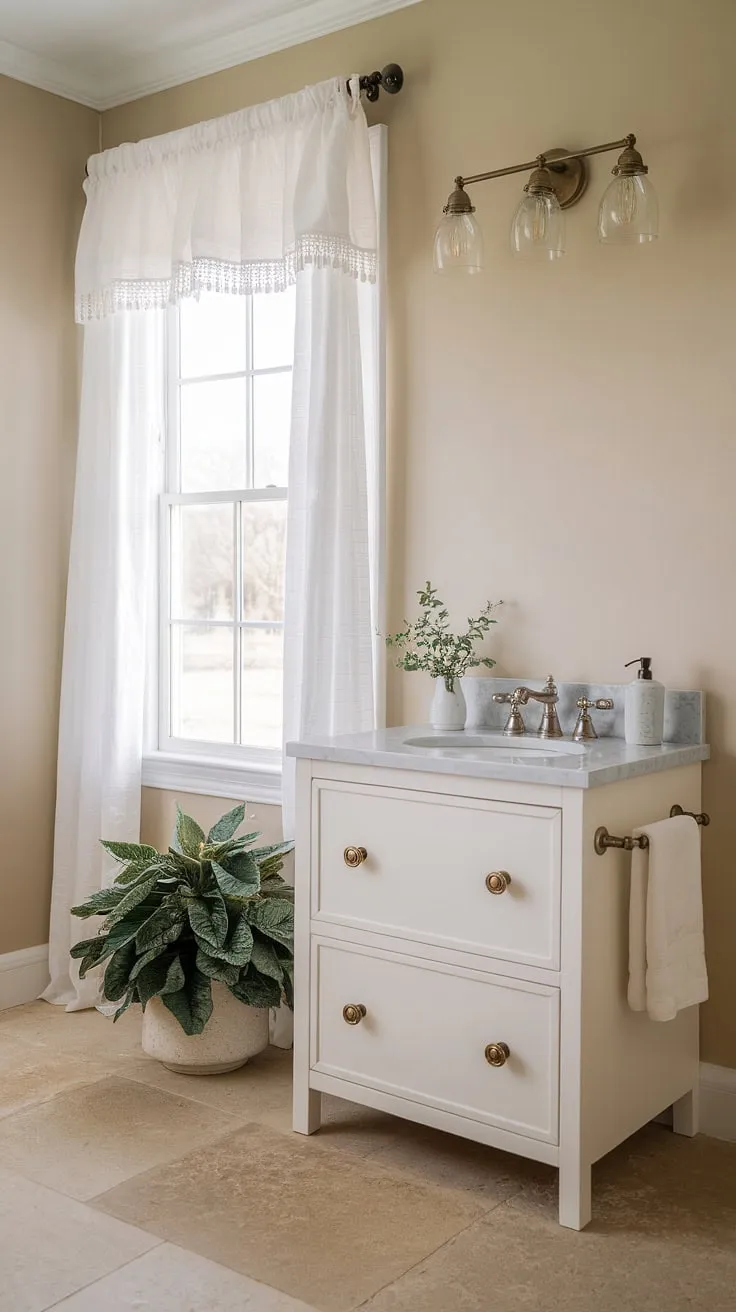 This a half bath is the epitome of understated elegance. The simple white vanity, soft beige walls, and natural light create a calming atmosphere. Every detail, from the brass knobs to the potted plant, contributes to its tranquil charm.