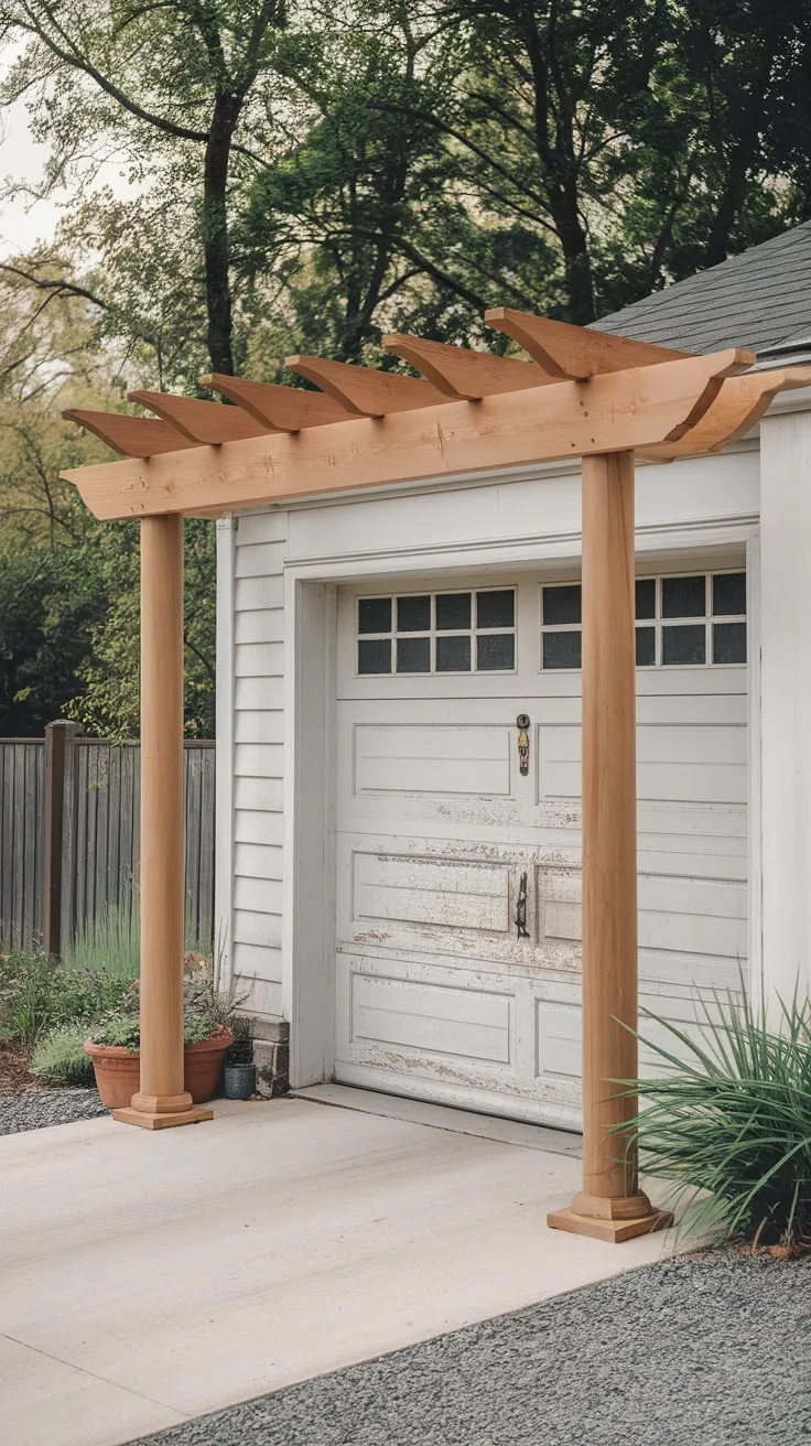 A quaint cedar pergola shelters a scratched white garage door, its four pillars and wooden beams framing a picturesque scene of potted plants and surrounding greenery.