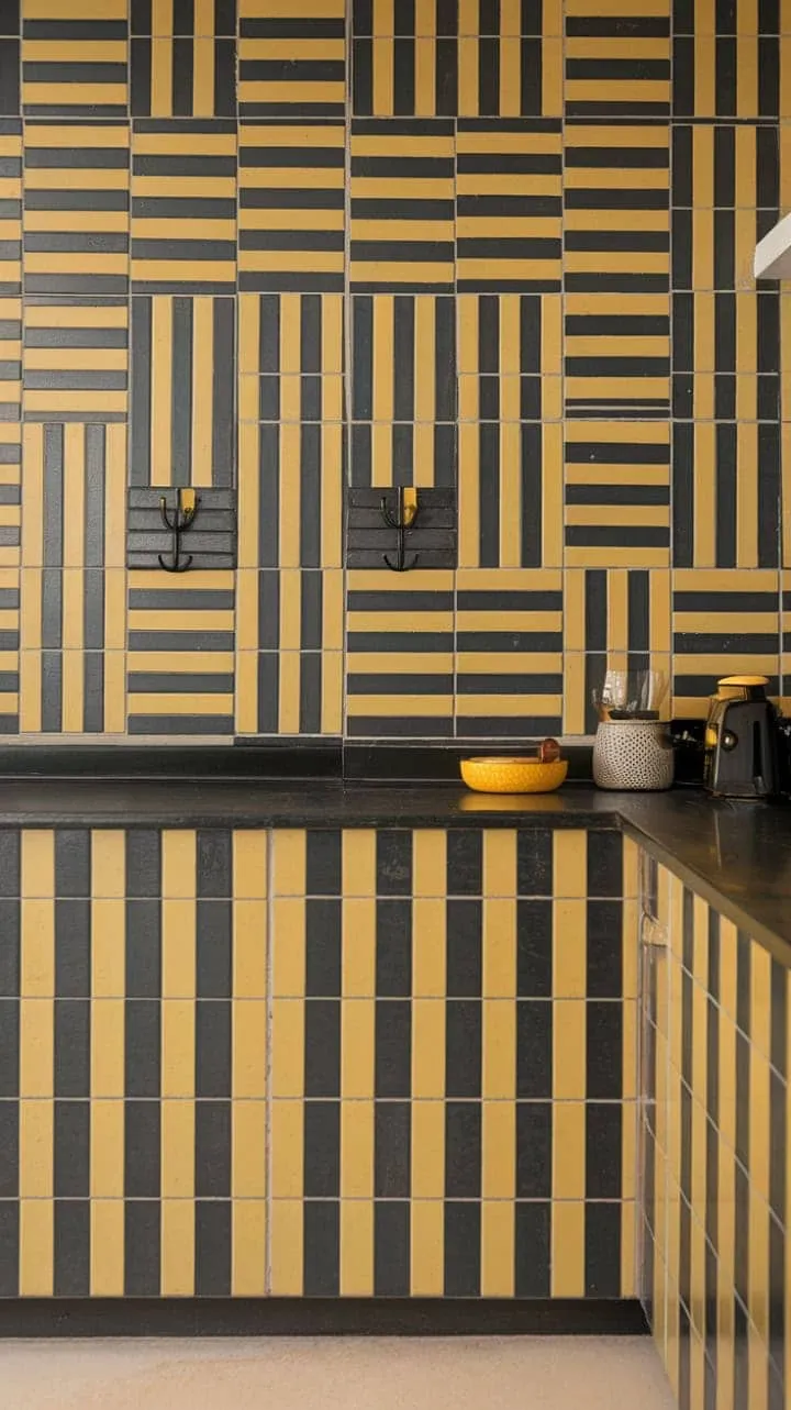 This mid-century kitchen captivates with its bold yellow and black backsplash, minimalist black countertops, and warm beige flooring, blending functionality with artistic flair.