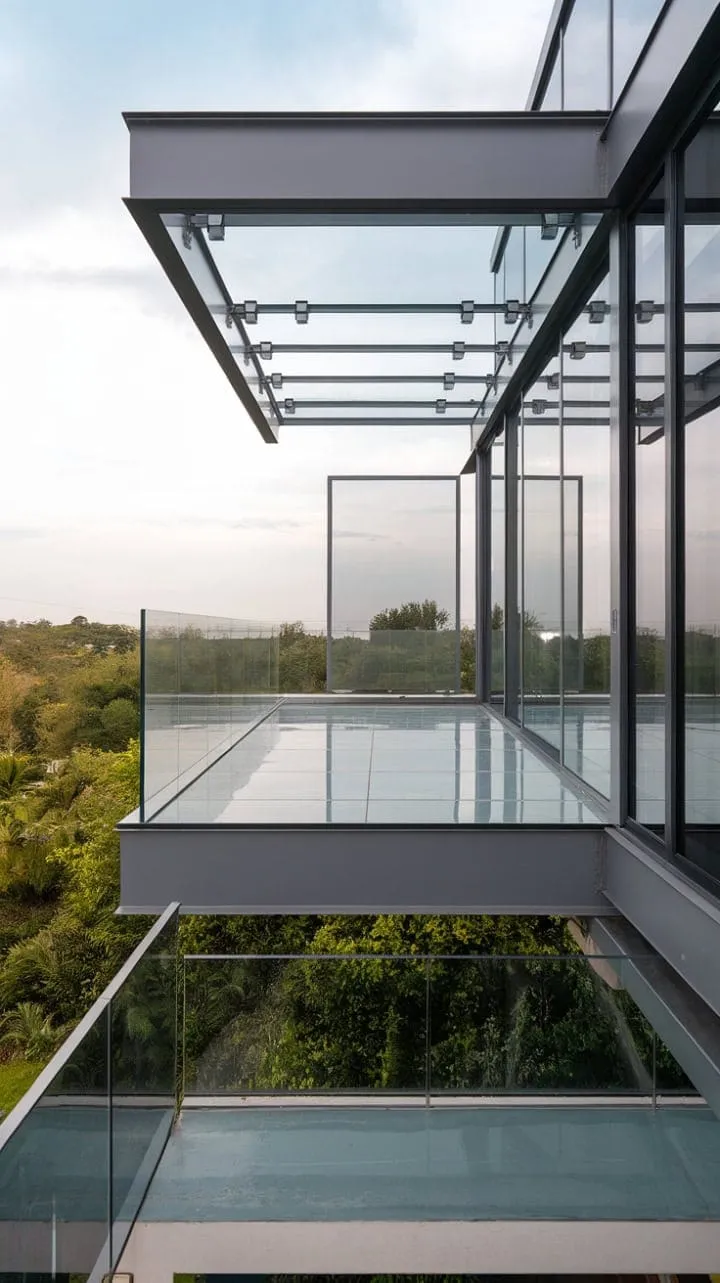Indulge in a serene escape with this contemporary glass balcony, where frameless design offers breathtaking views and a perfect blend of luxury and safety.