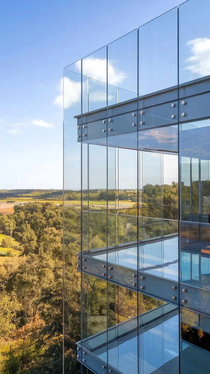 Experience breathtaking panoramas and a serene outdoor connection with this modern glass balcony, elegantly framed for both security and style.