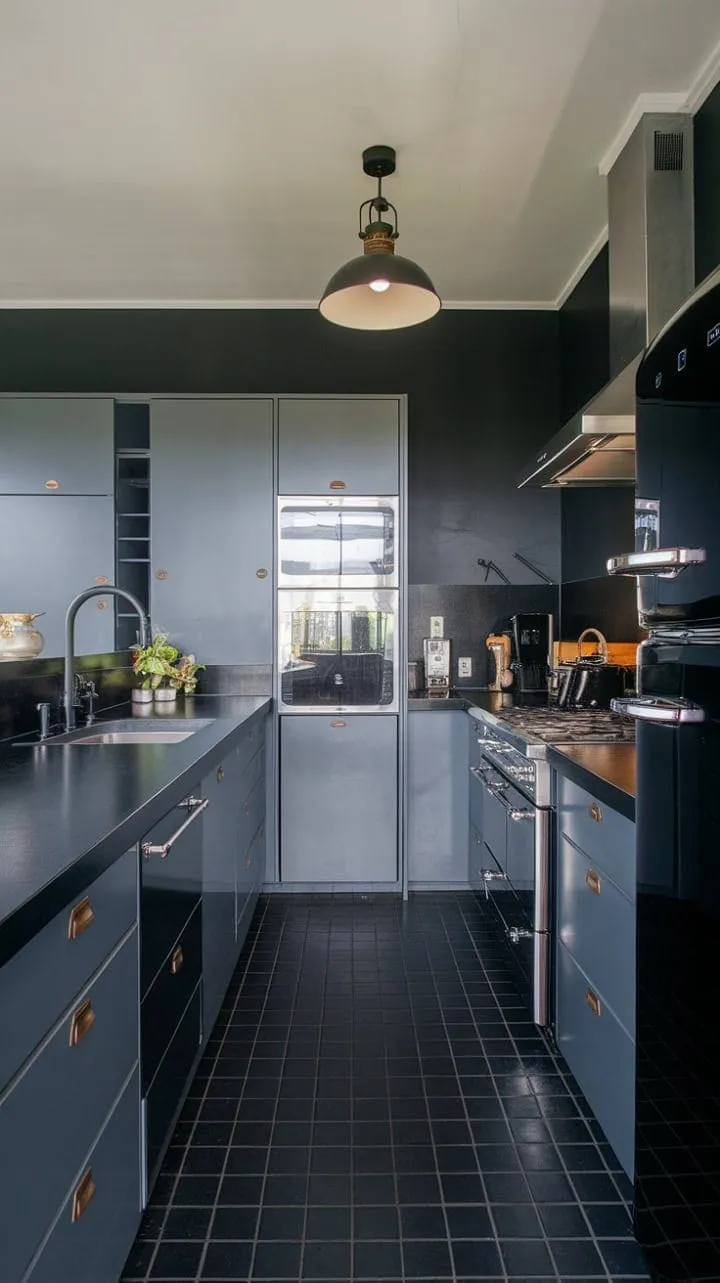 This sophisticated kitchen blends moody hues of grey and black with sleek stainless steel, creating a stylish sanctuary for culinary enthusiasts and social hosts alike.