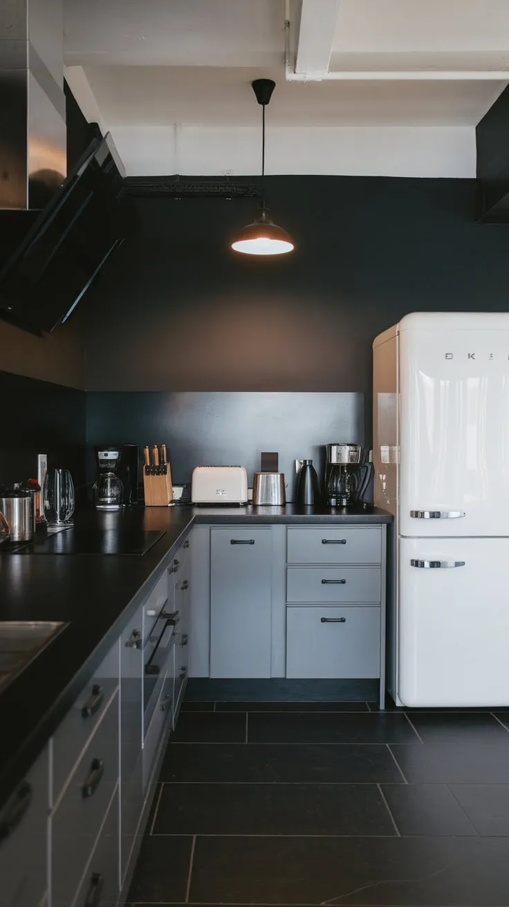 Sleek grey cabinets, black countertops, and dark grey tiles create a sophisticated urban kitchen aesthetic.