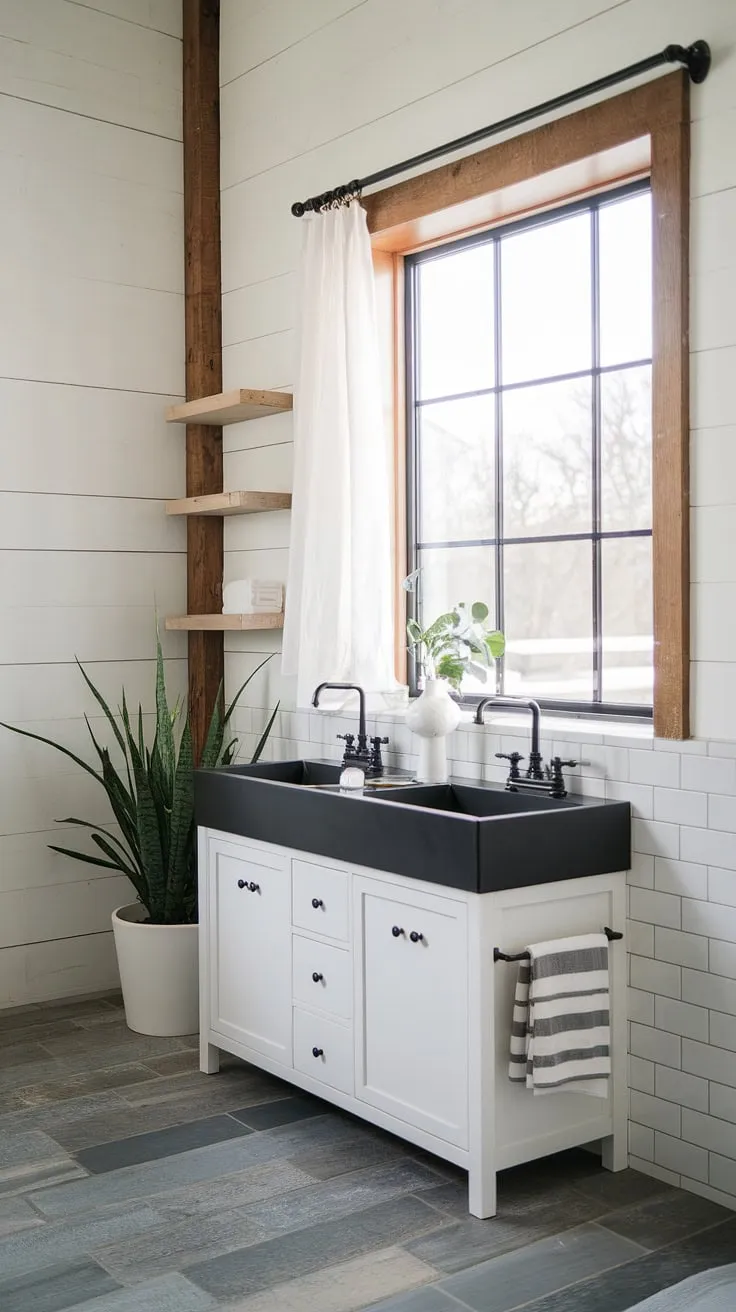 With its simple yet stylish design, this modern farmhouse bathroom showcases key elements like a white vanity, black sink, and natural accents, perfect for anyone seeking modern farmhouse bathroom ideas.