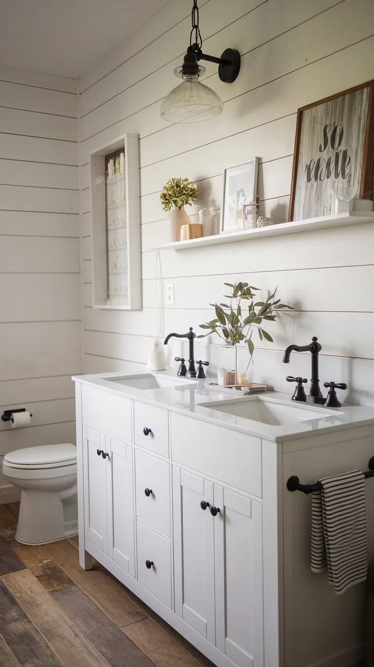 This stunning modern farmhouse bathroom features a white vanity with a double sink, rustic light fixture, and wood plank flooring, making it a perfect inspiration for master bathroom ideas and bathroom remodel designs.