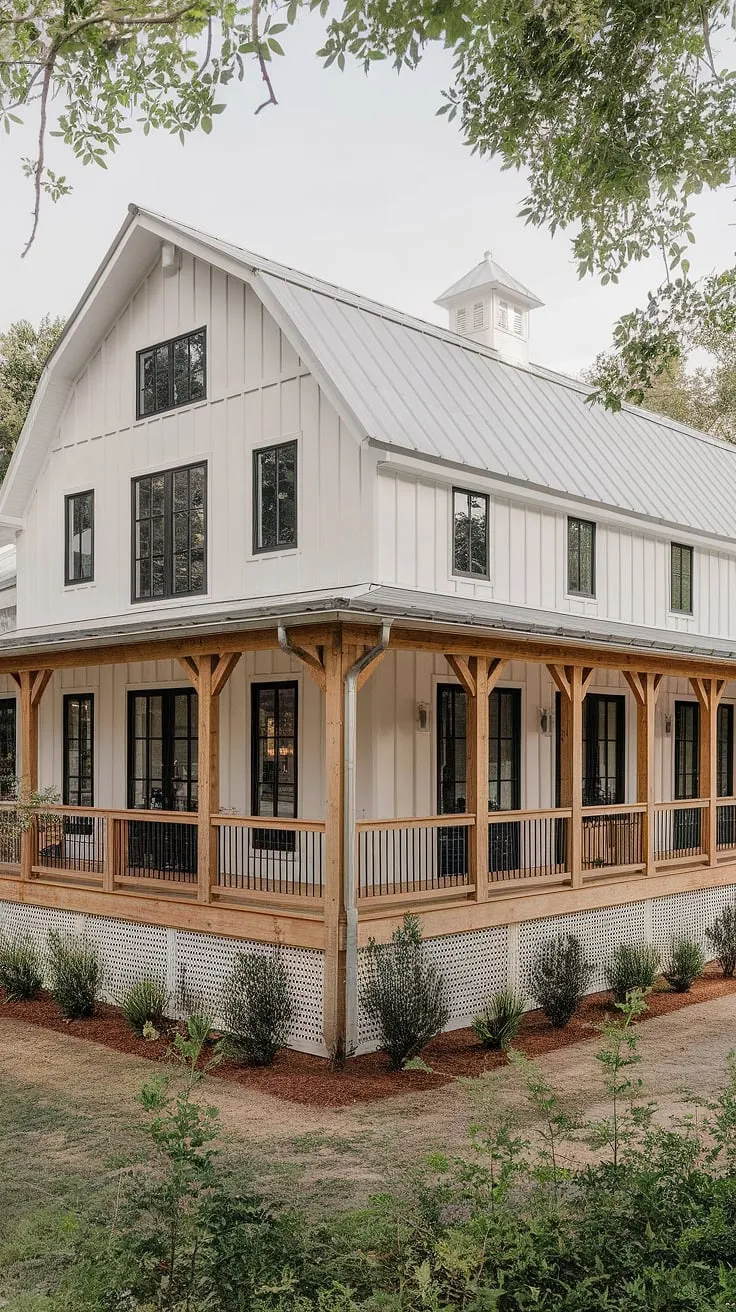 This stunning modern farmhouse features a large L-shape porch, a white rustic exterior with black windows and wood accents, and a charming barn-style design that beautifully blends modern and rustic aesthetics.