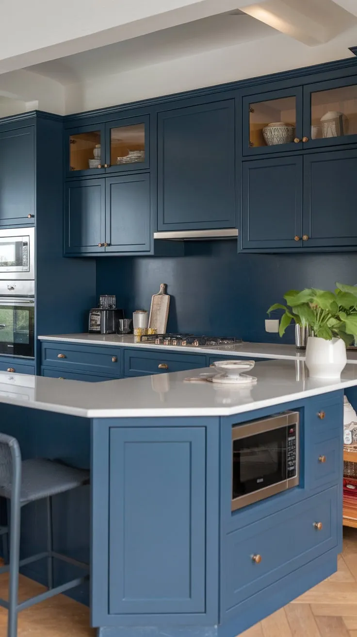 A stylish modern kitchen boasts dark blue accents, high-end materials, and an inviting island.