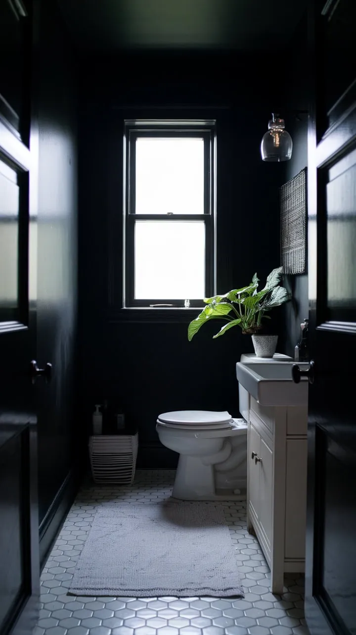 In a serene sanctuary of contrasts, dark walls and white fixtures harmonize with soft light and a hint of green, creating a moody yet minimalist retreat.