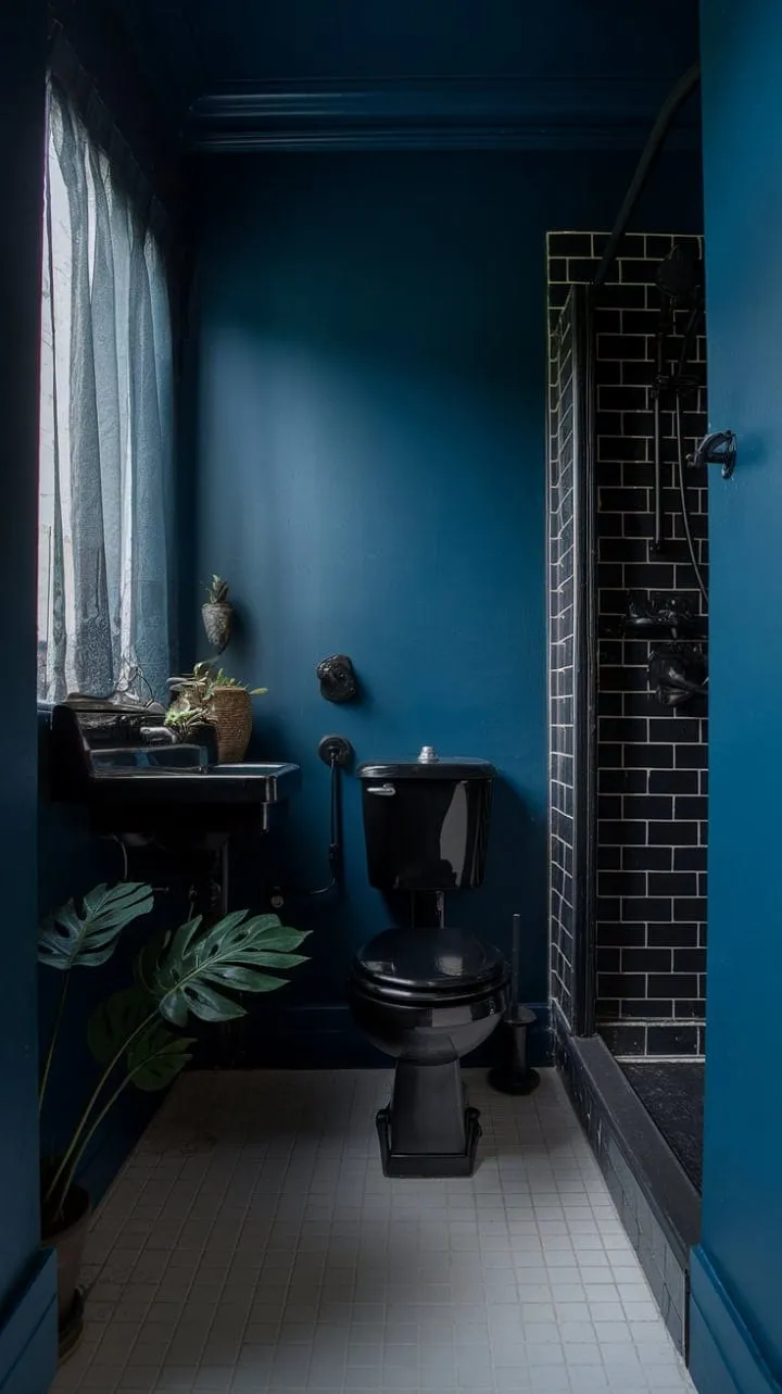 In a moody sanctuary of dark blue walls and black fixtures, a soft window glow and greenery invite serene luxury in minimalist design.
