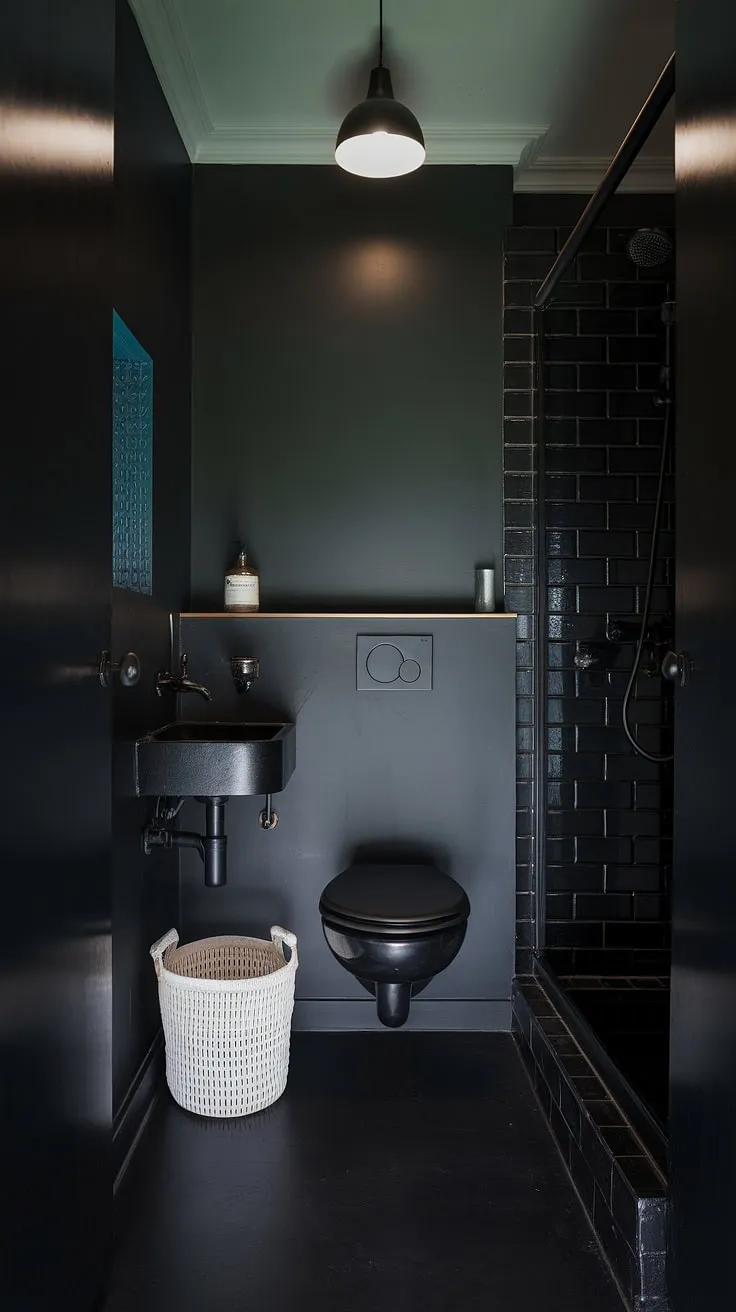 This moody bathroom features a dark powder room aesthetic with black finishes, a tiny layout, and stylish elements perfect for a bathroom remodel.