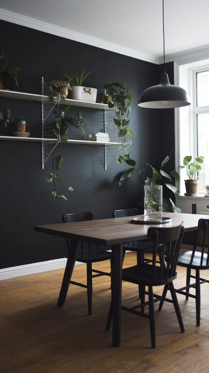 In a striking Scandinavian dining room, deep black walls and sleek chairs harmonize with a warm wooden table and vibrant greenery, creating an inviting haven for culinary enjoyment and reflection.