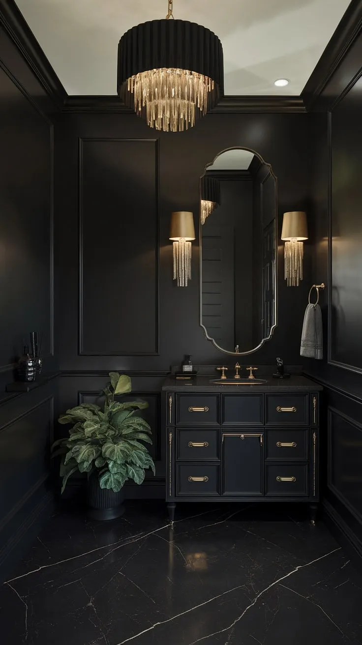 This moody black powder room exudes luxury with its black marble floor, gold accents, and elegant decor, creating a stunning dark bathroom oasis.