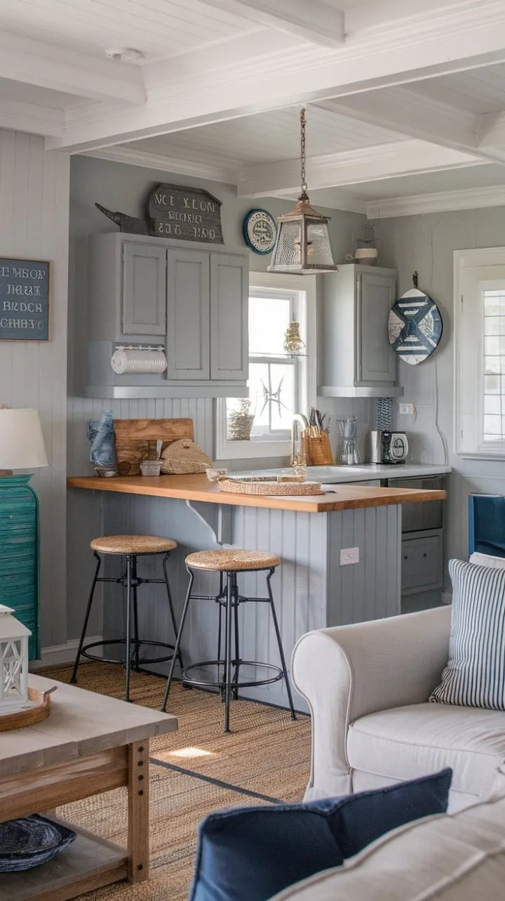 This stunning open-plan space harmoniously blends coastal charm with farmhouse functionality, featuring calming gray cabinets, a warm wood island, and nautical accents for a serene yet elegant atmosphere.