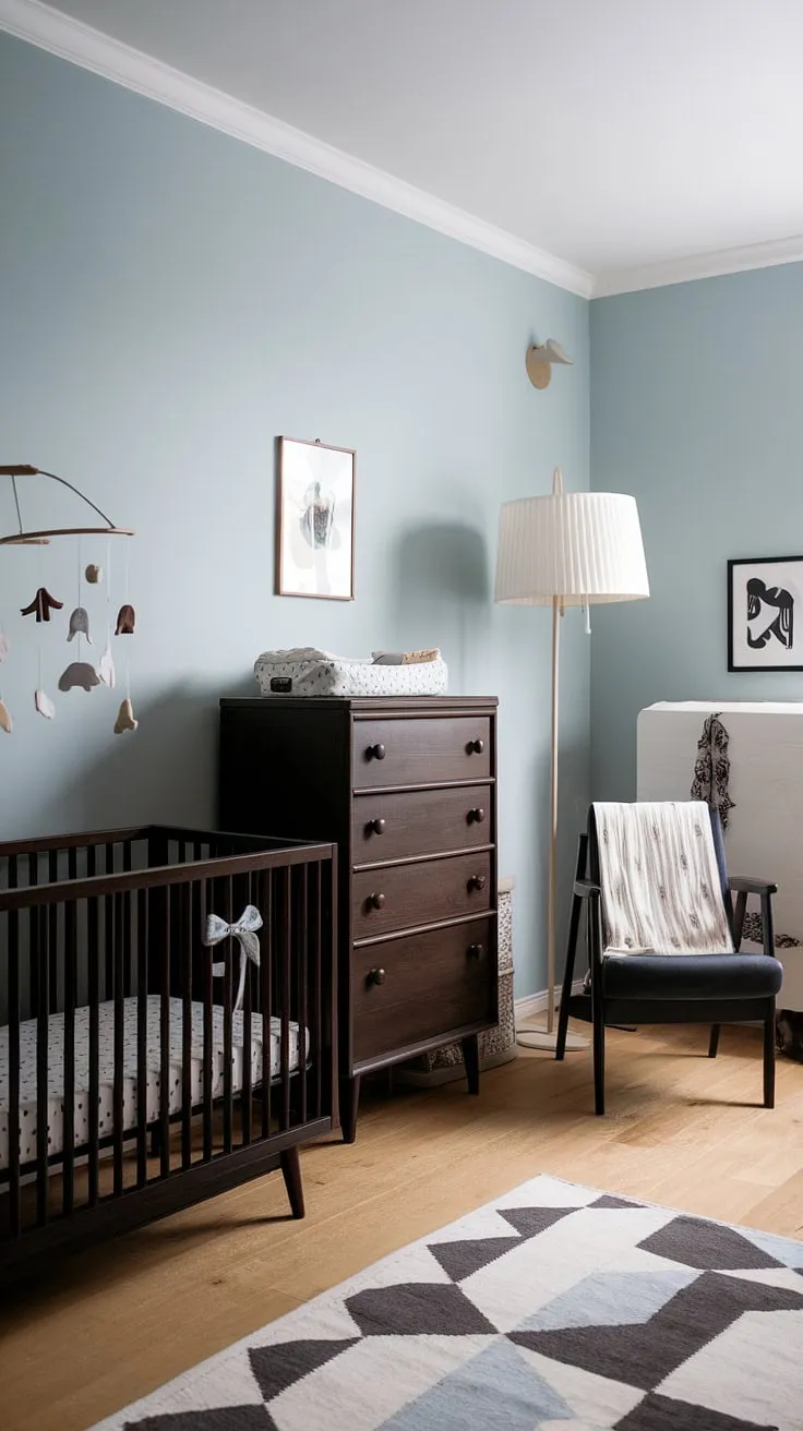 Soft blue walls and the warm glow of natural light create a haven of calm in this Scandinavian nursery. Dark wood furniture, a vintage mobile, and thoughtfully chosen details whisper of quiet comfort and peaceful nights. A perfect blend of style and functionality, this space is designed for both parent and child. A sanctuary of serenity, A place of dreams, A space to grow.