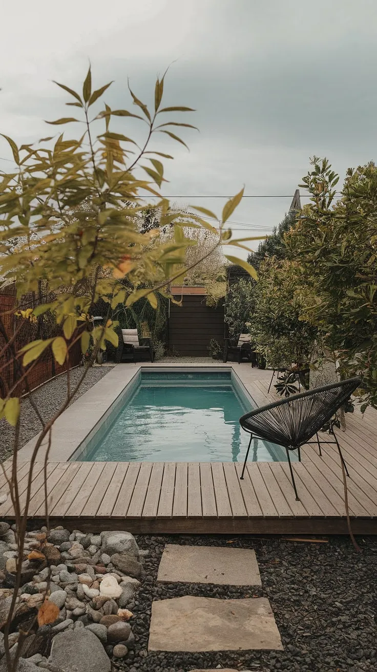Escape the everyday in this cozy backyard oasis.  This small pool backyard offers a perfect blend of modern design and tranquil landscaping, proving that stunning backyard landscaping with pool ideas are achievable even in small spaces.  The small garden with pool adds a touch of nature, while the wooden deck provides the perfect spot to relax.  This is the epitome of small backyard pool landscaping, showcasing small backyard with pool ideas and small modern pool designs that are both stylish and budget-friendly.  Consider this your inspiration for plunge pool ideas small spaces and cozy backyard ideas on a budget.