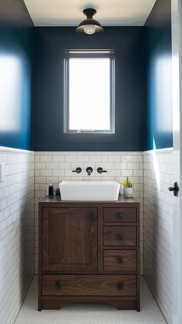 A custom bathroom vanity is the star of this small guest bathroom. The dark wood adds warmth and sophistication to this tiny powder room, while the deep blue walls create a luxurious and intimate atmosphere. Clever design solutions make this small powder room feel spacious and elegant, showcasing the best in small guest bathroom ideas for half baths and powder room vanity options.