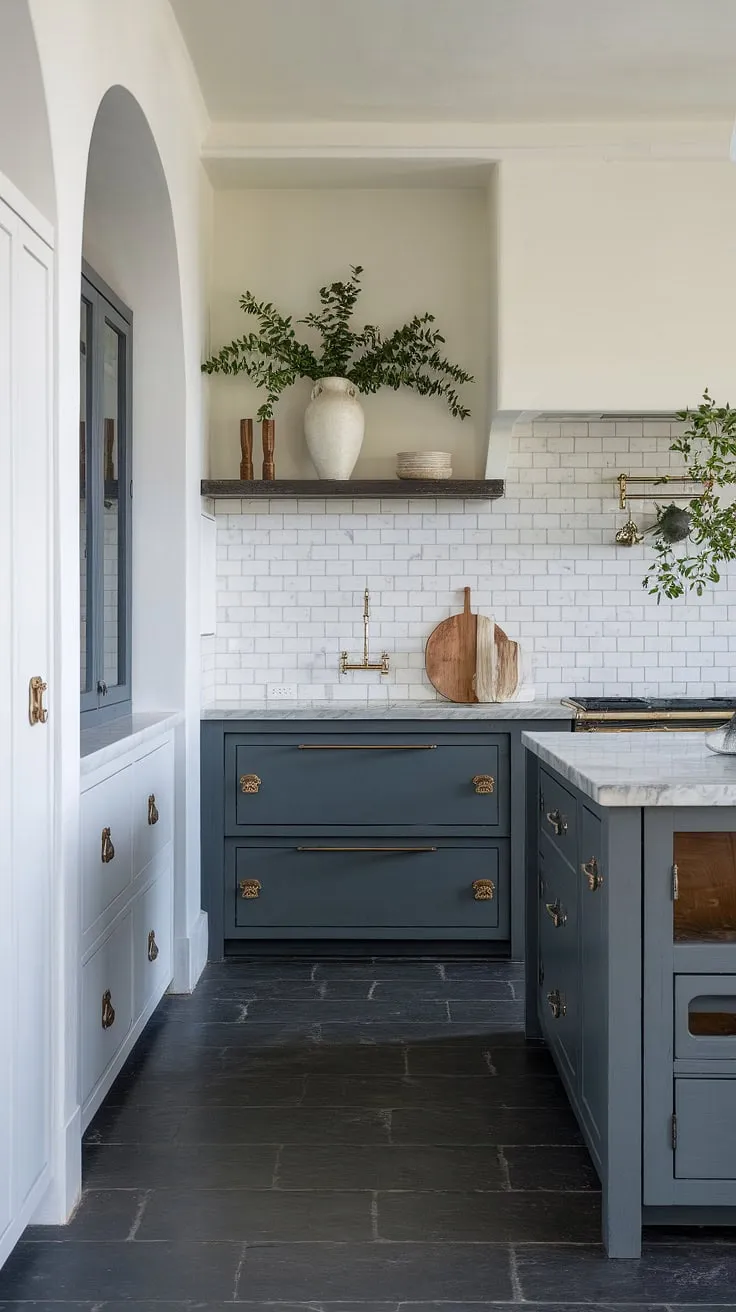 A chic Mediterranean kitchen blends Spanish style with a sophisticated contrast of dark gray and white, highlighted by marble and white backsplash.