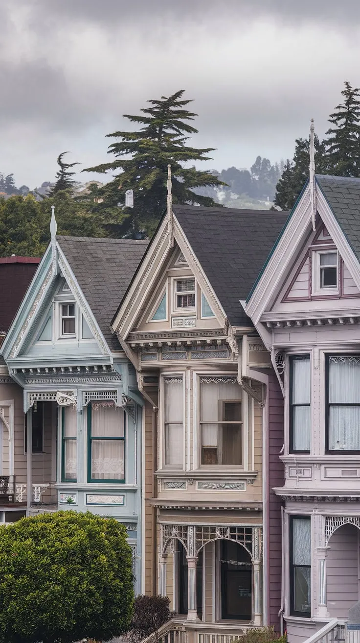 A row of colorful Victorian homes, detailed with scrollwork and bay windows, stand proudly under a cloudy sky.